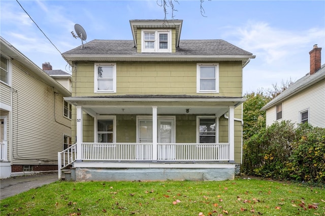 view of front facade with a front yard and covered porch