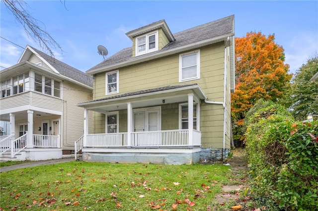 view of front of house with a porch and a front lawn