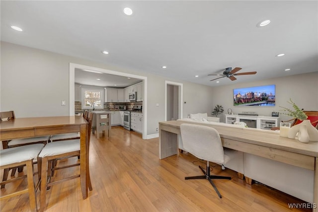 home office featuring sink and light wood-type flooring