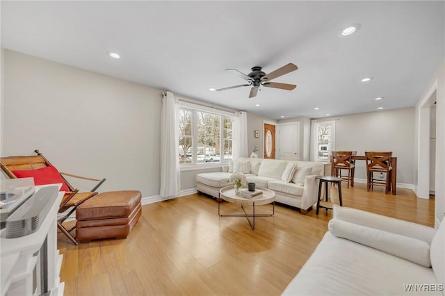 living room with ceiling fan and light hardwood / wood-style floors