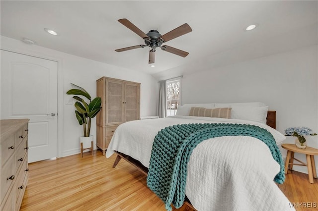 bedroom with ceiling fan and light hardwood / wood-style floors