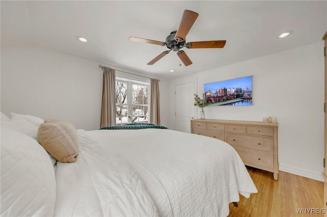 bedroom with ceiling fan and light hardwood / wood-style flooring