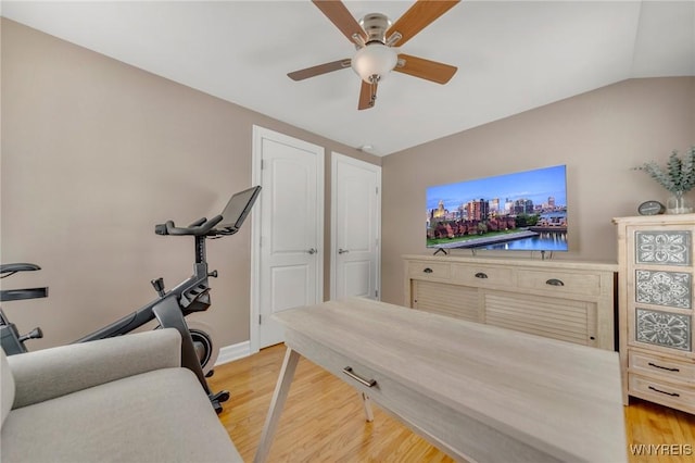 workout room featuring vaulted ceiling, hardwood / wood-style floors, and ceiling fan