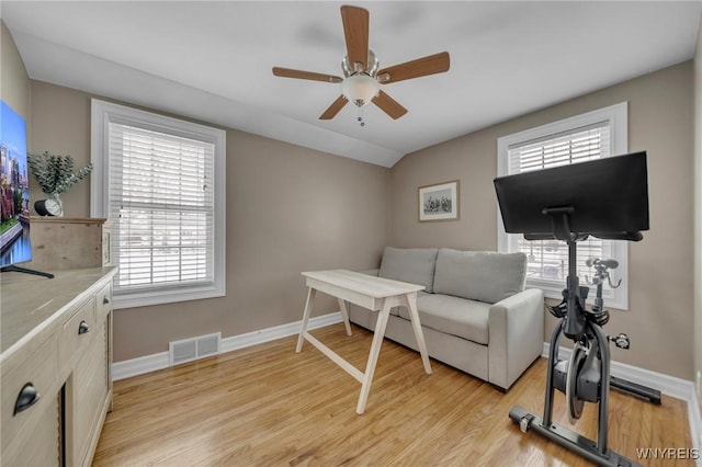 interior space featuring ceiling fan, lofted ceiling, plenty of natural light, and light wood-type flooring