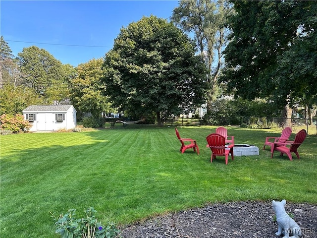 view of yard featuring an outdoor fire pit and a storage unit