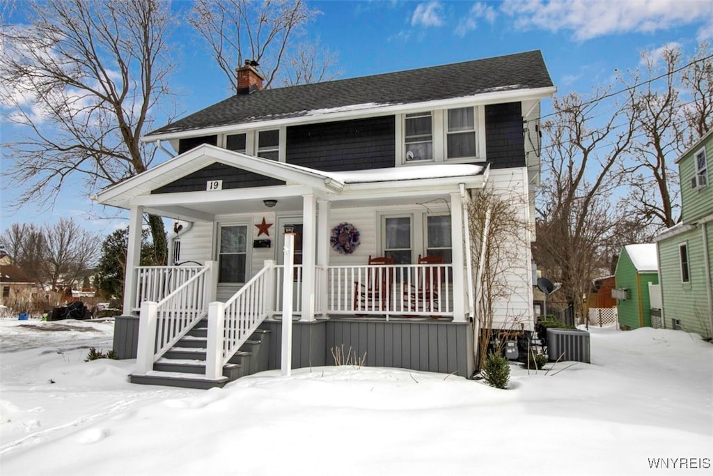 view of front facade featuring central AC unit and covered porch