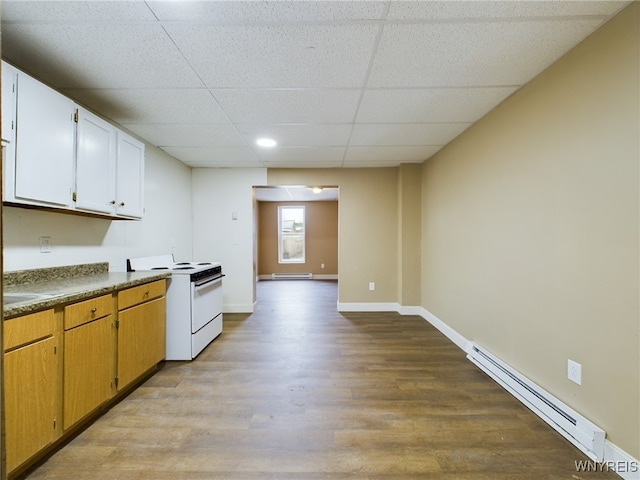 kitchen featuring light hardwood / wood-style flooring, a paneled ceiling, a baseboard heating unit, white range with electric stovetop, and white cabinets