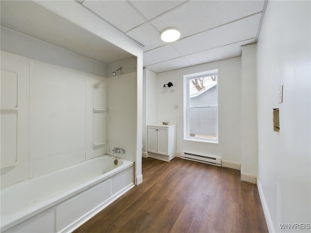 bathroom featuring a paneled ceiling, shower / washtub combination, vanity, hardwood / wood-style flooring, and a baseboard heating unit