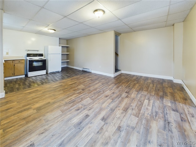 unfurnished living room featuring dark wood-type flooring, a paneled ceiling, and baseboard heating