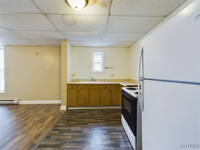 kitchen featuring range with electric stovetop, white fridge, sink, and a paneled ceiling