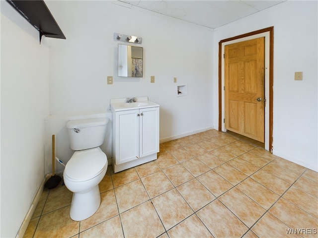 bathroom with tile patterned flooring, vanity, and toilet