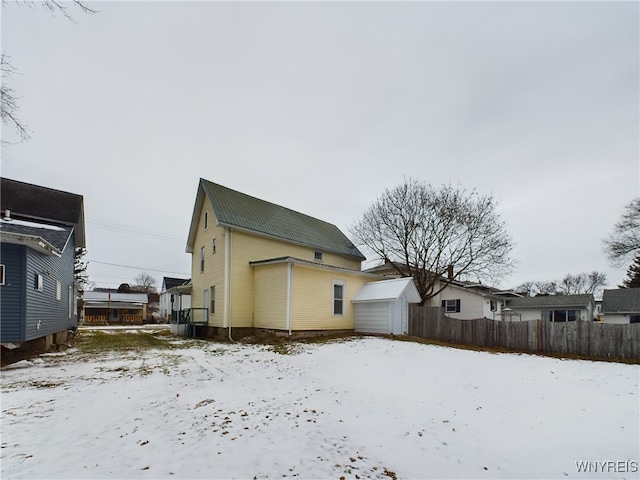 view of snow covered rear of property