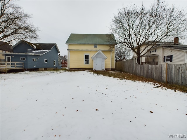 view of snow covered rear of property