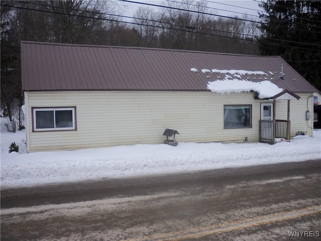 view of snow covered rear of property