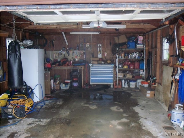 garage featuring a garage door opener and a workshop area