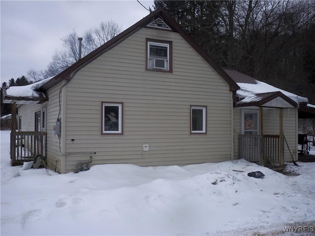 view of snow covered back of property