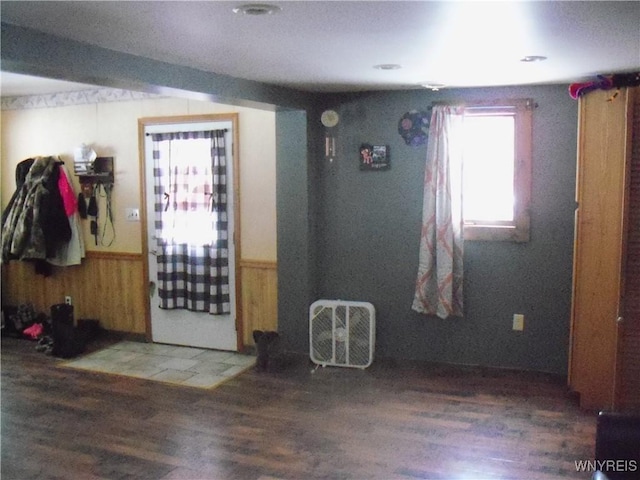 interior space with hardwood / wood-style floors and wood walls