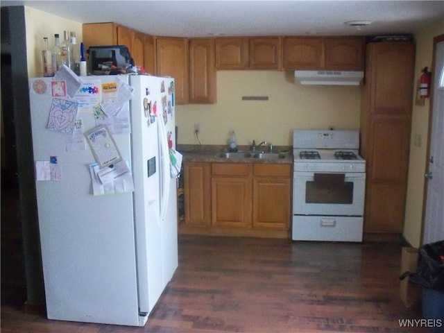 kitchen with dark wood-type flooring, white appliances, and sink