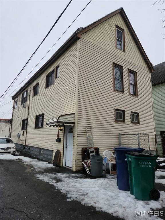 view of snow covered rear of property