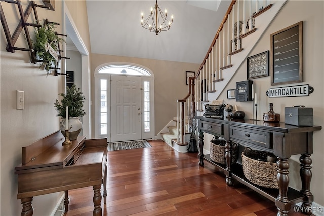 foyer with an inviting chandelier and dark hardwood / wood-style floors