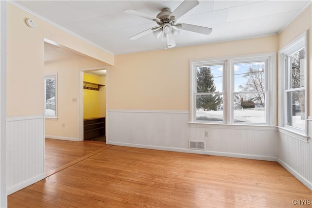 unfurnished room featuring crown molding, ceiling fan, and light hardwood / wood-style floors