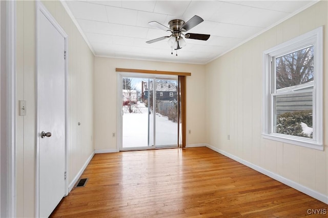 unfurnished room with ceiling fan, ornamental molding, and light hardwood / wood-style flooring