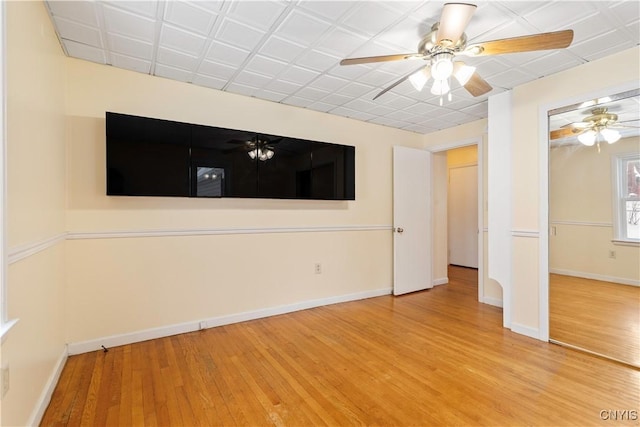 unfurnished room with hardwood / wood-style floors and ceiling fan