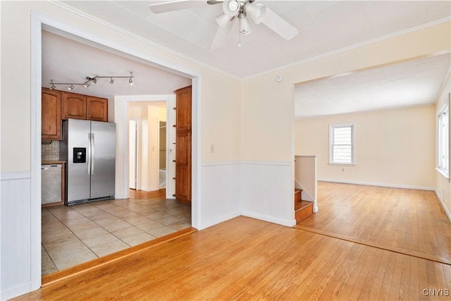 interior space with light hardwood / wood-style flooring, ornamental molding, ceiling fan, and track lighting