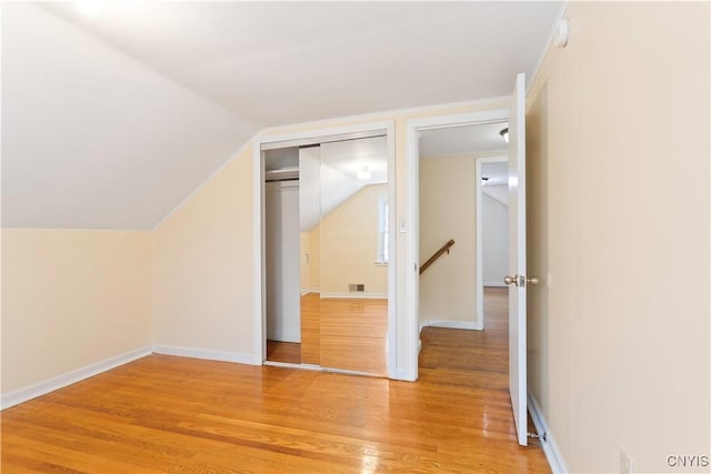 bonus room featuring wood-type flooring and lofted ceiling