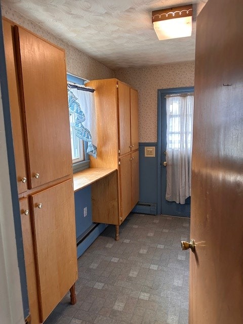 mudroom with a baseboard radiator and a textured ceiling