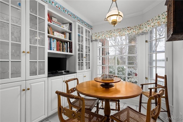 dining room with crown molding and a healthy amount of sunlight