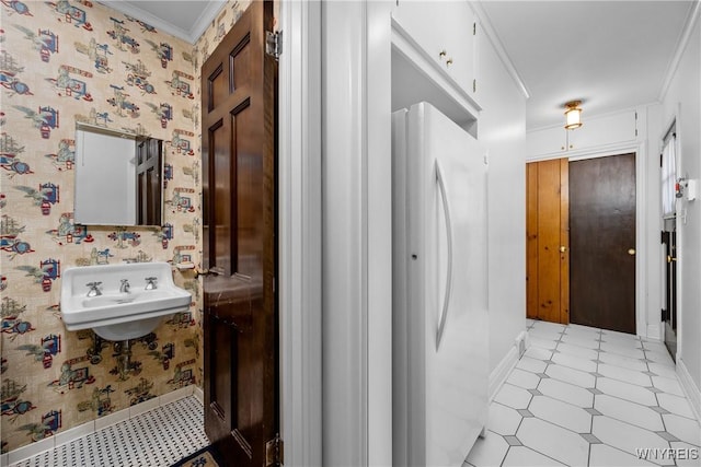 bathroom featuring ornamental molding and sink