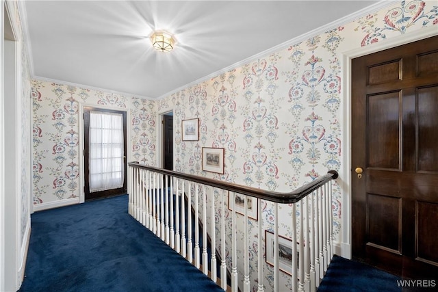 hallway with ornamental molding and dark carpet