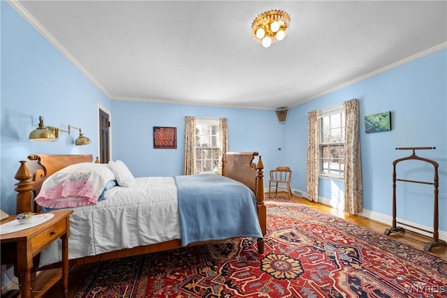 bedroom featuring ornamental molding and hardwood / wood-style floors