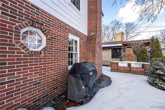 snow covered patio with grilling area