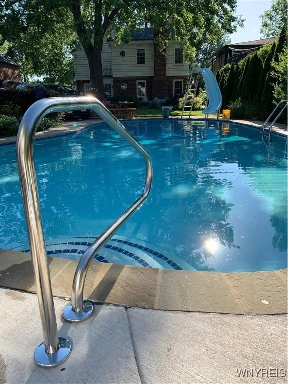 view of swimming pool with a water slide