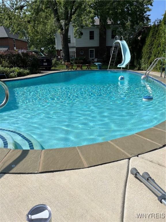 view of pool with a water slide