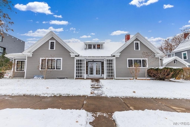 view of snow covered rear of property