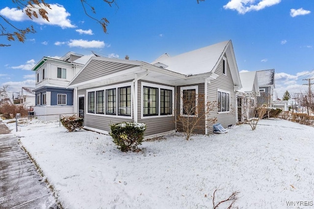 view of snow covered rear of property