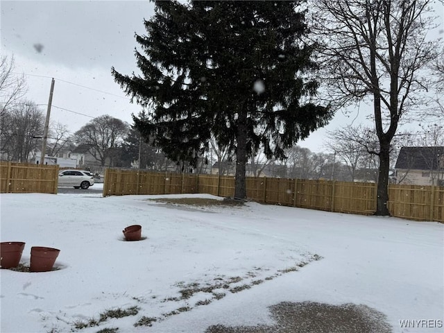 view of yard layered in snow