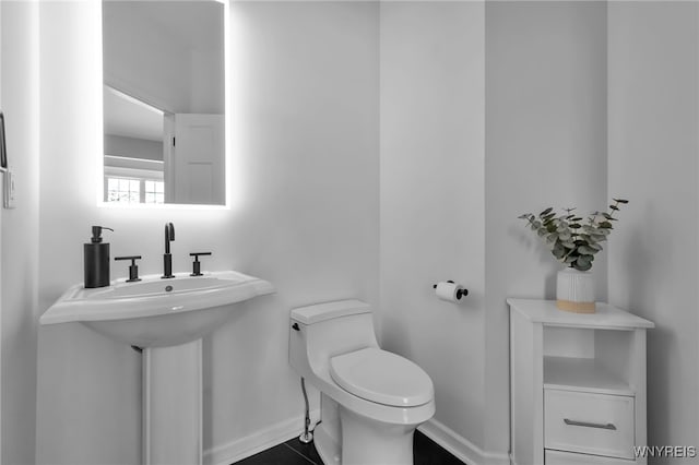 bathroom with sink, tile patterned floors, and toilet