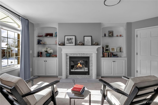 carpeted living room featuring built in features