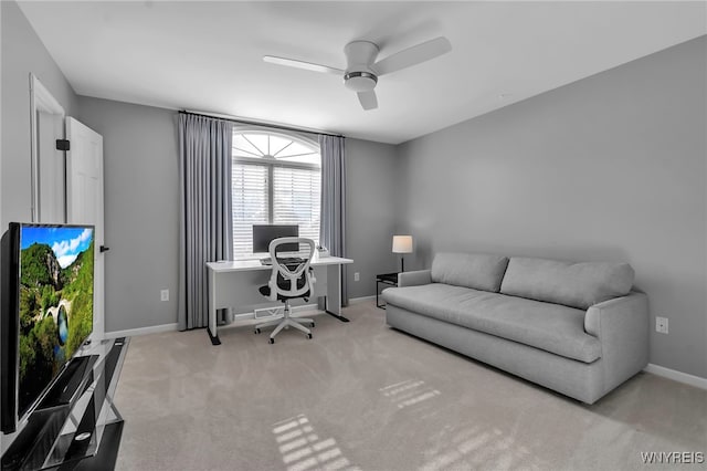 carpeted home office featuring ceiling fan