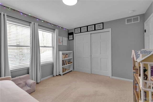 bedroom with a closet and light carpet