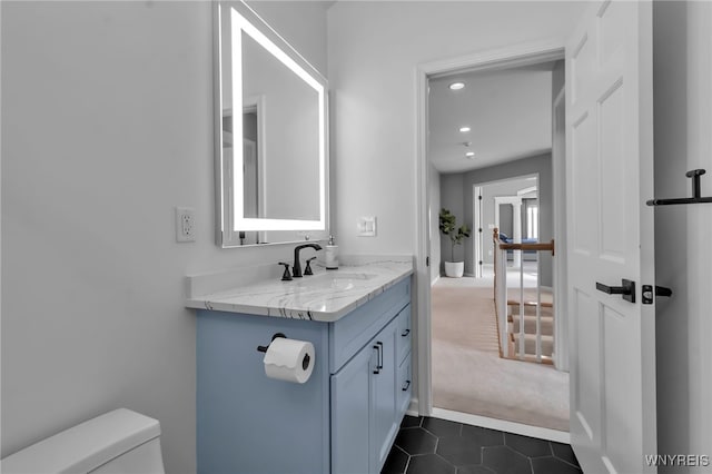 bathroom with vanity, toilet, and tile patterned flooring