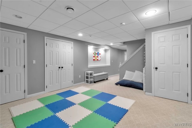 playroom featuring a paneled ceiling and light colored carpet