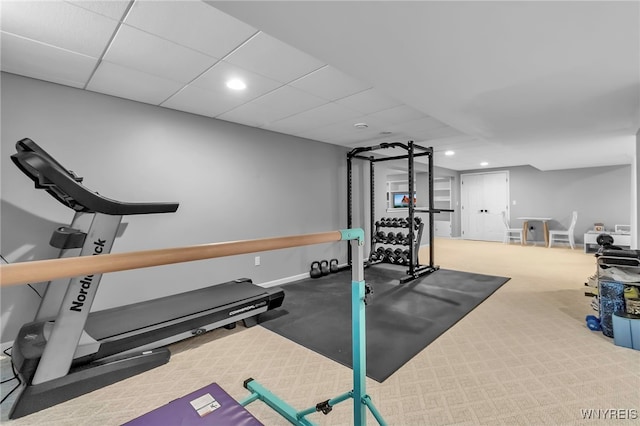 workout room with a drop ceiling and carpet floors