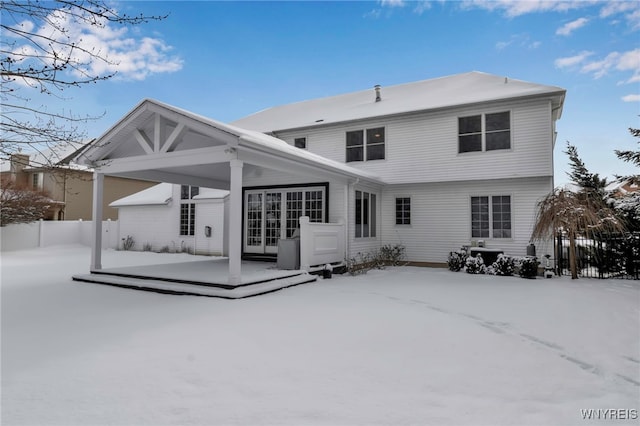 view of snow covered rear of property