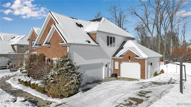 view of snow covered exterior with central AC