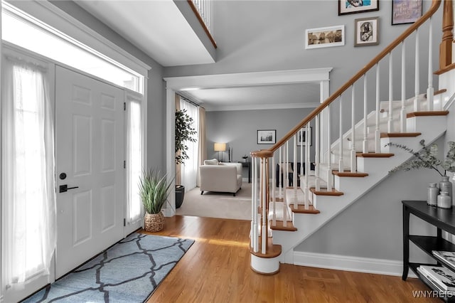 entrance foyer featuring hardwood / wood-style floors and crown molding